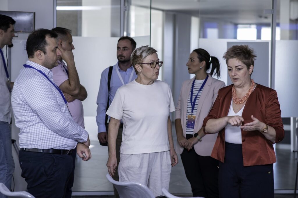 Innovative business team discussion at IMPETUS conference in modern office environment.