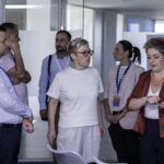 Innovative business team discussion at IMPETUS conference in modern office environment.