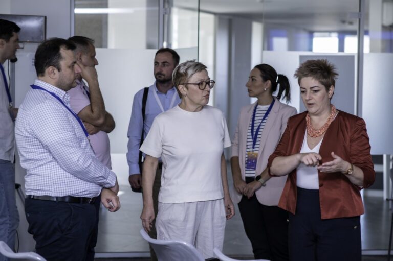 Innovative business team discussion at IMPETUS conference in modern office environment.