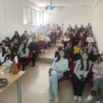 Students attending an educational lecture on cybersecurity during school visit.