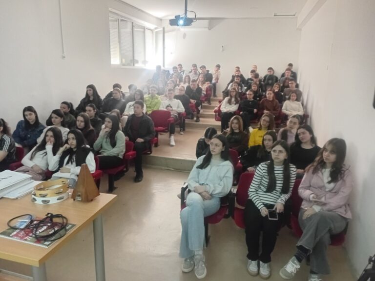 Students attending an educational lecture on cybersecurity during school visit.