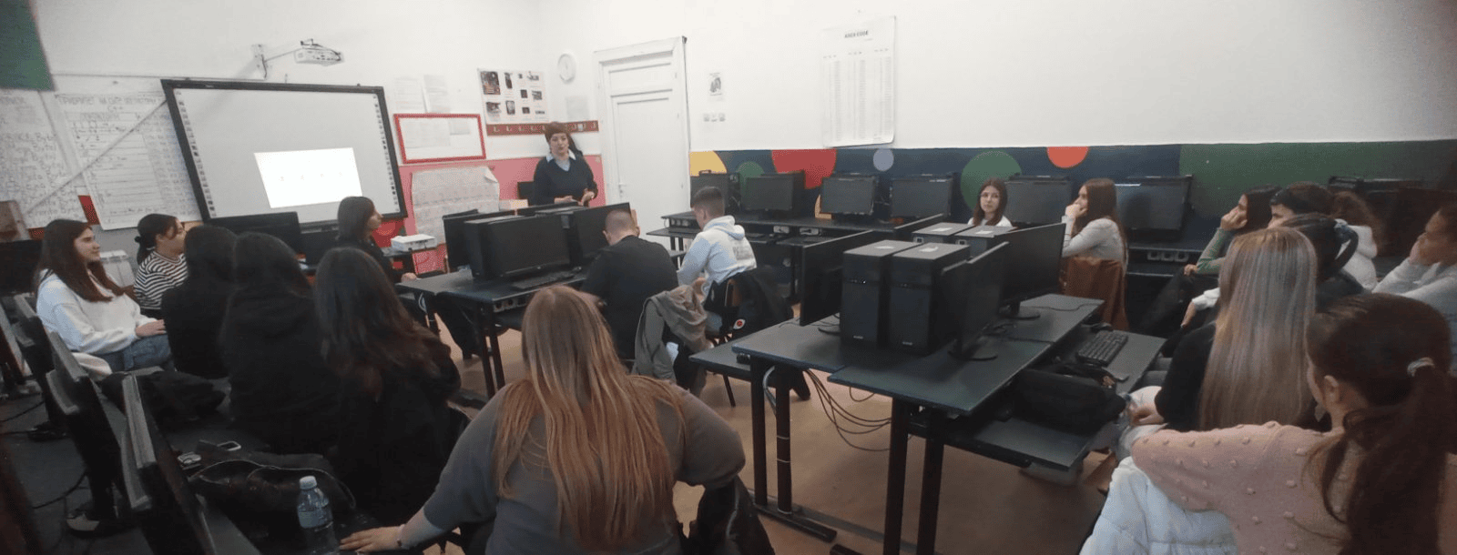 High school visit with students and teacher during educational tour.