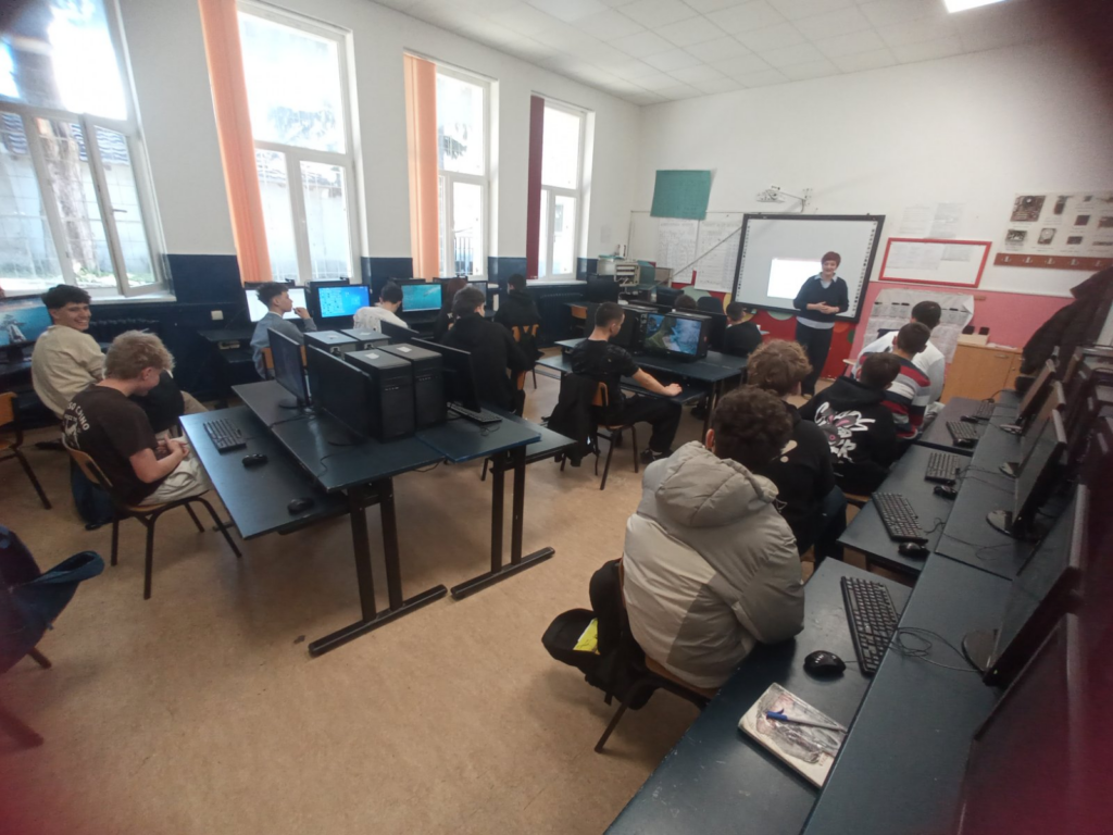 Students attending a computer class during a school visit.