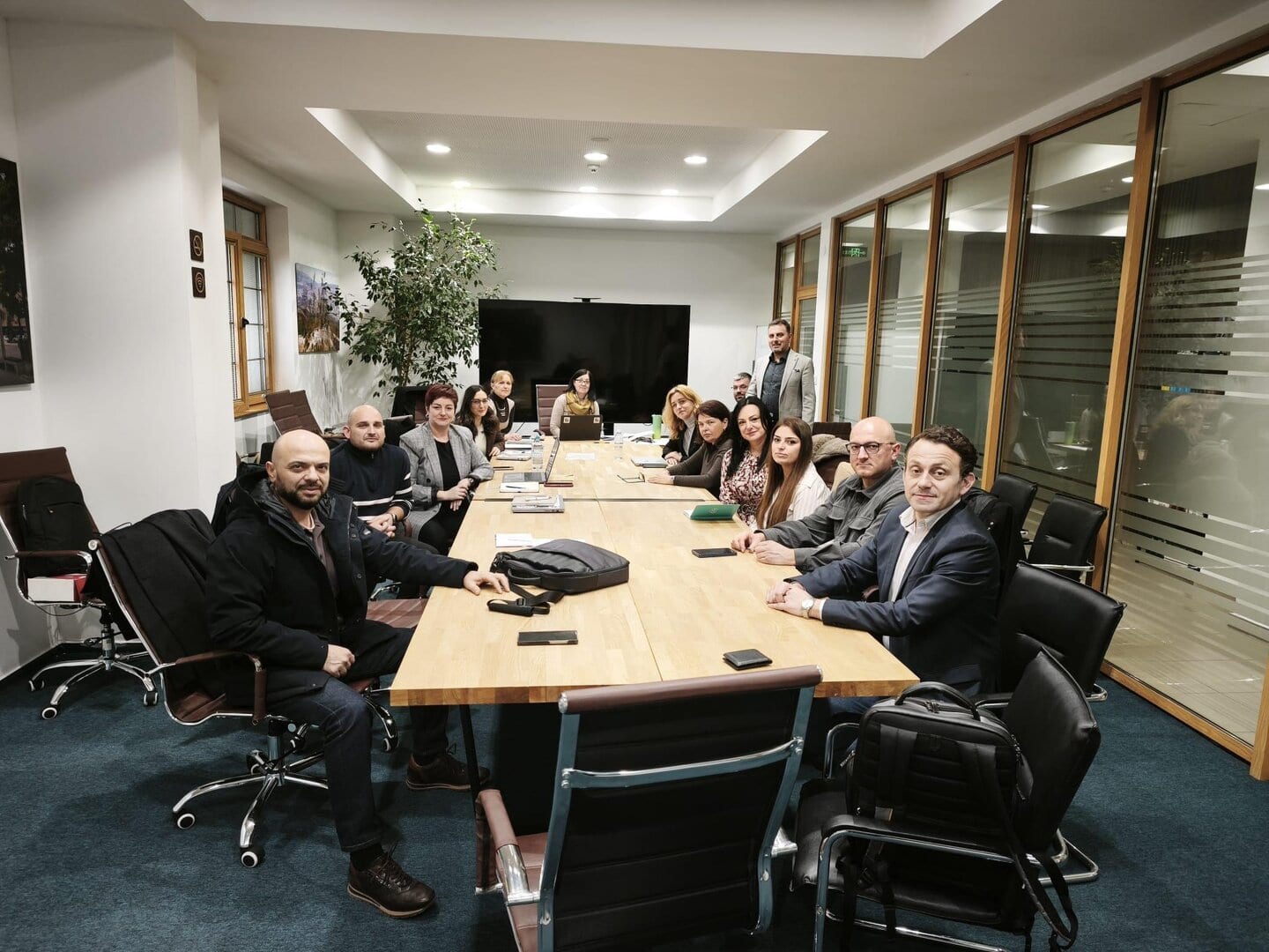 Team meeting in modern conference room at Impetus office for business growth.